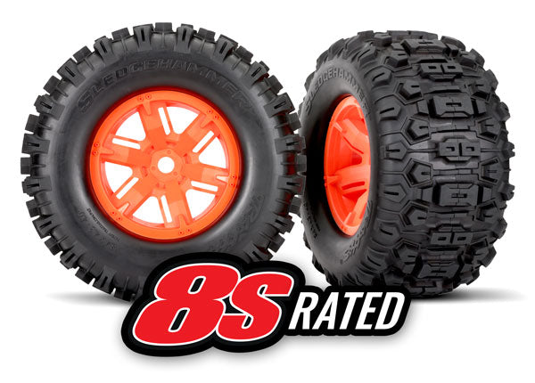 7774T Tires & wheels, assembled, glued (X-Maxx® orange wheels, Sledgehammer® tires, foam inserts) (left & right) (2)